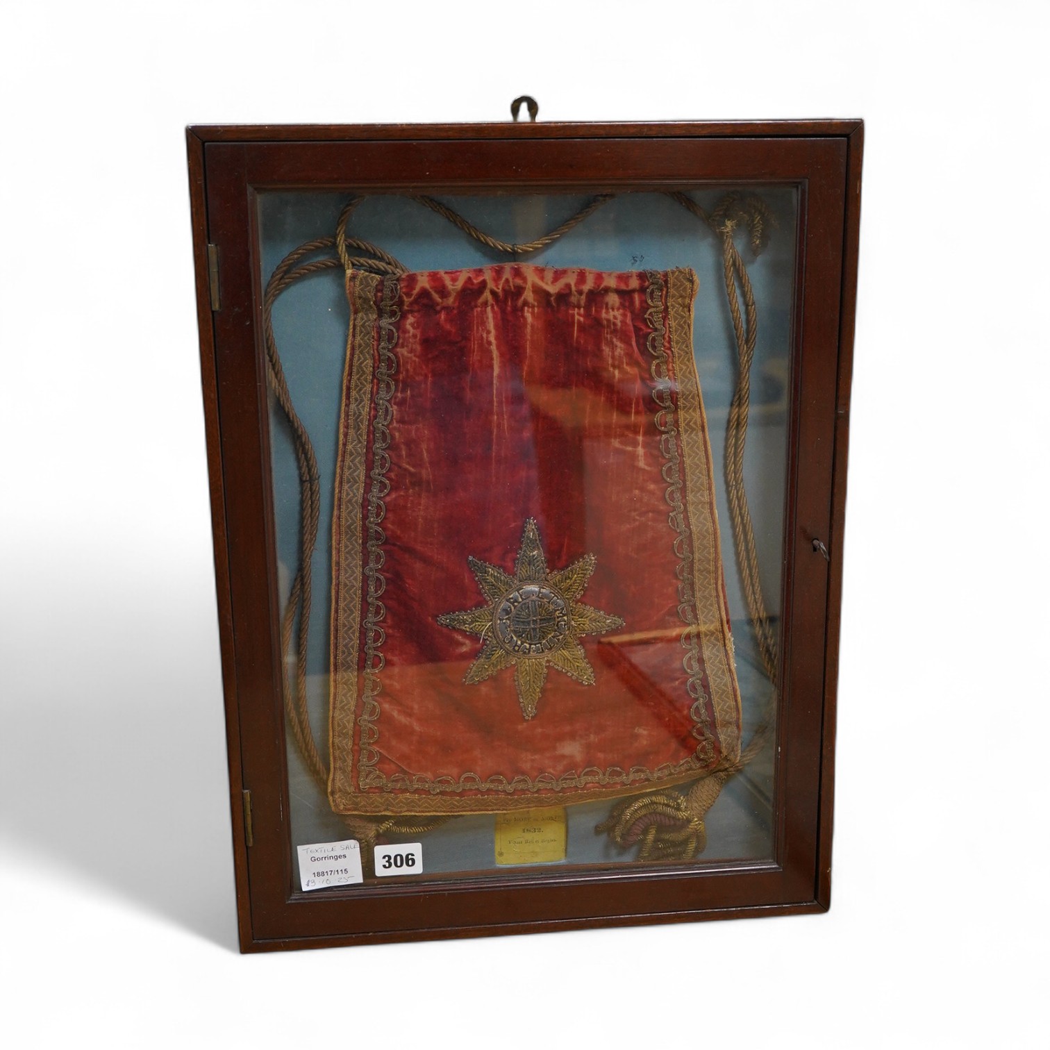 Eton interest - a commemorative William IV, ceremonial red velvet, gold metallic thread, tasselled and braided bag, mounted within a mahogany glazed cabinet. An old printed ticket in Latin mounted beneath: Pro More et Mo